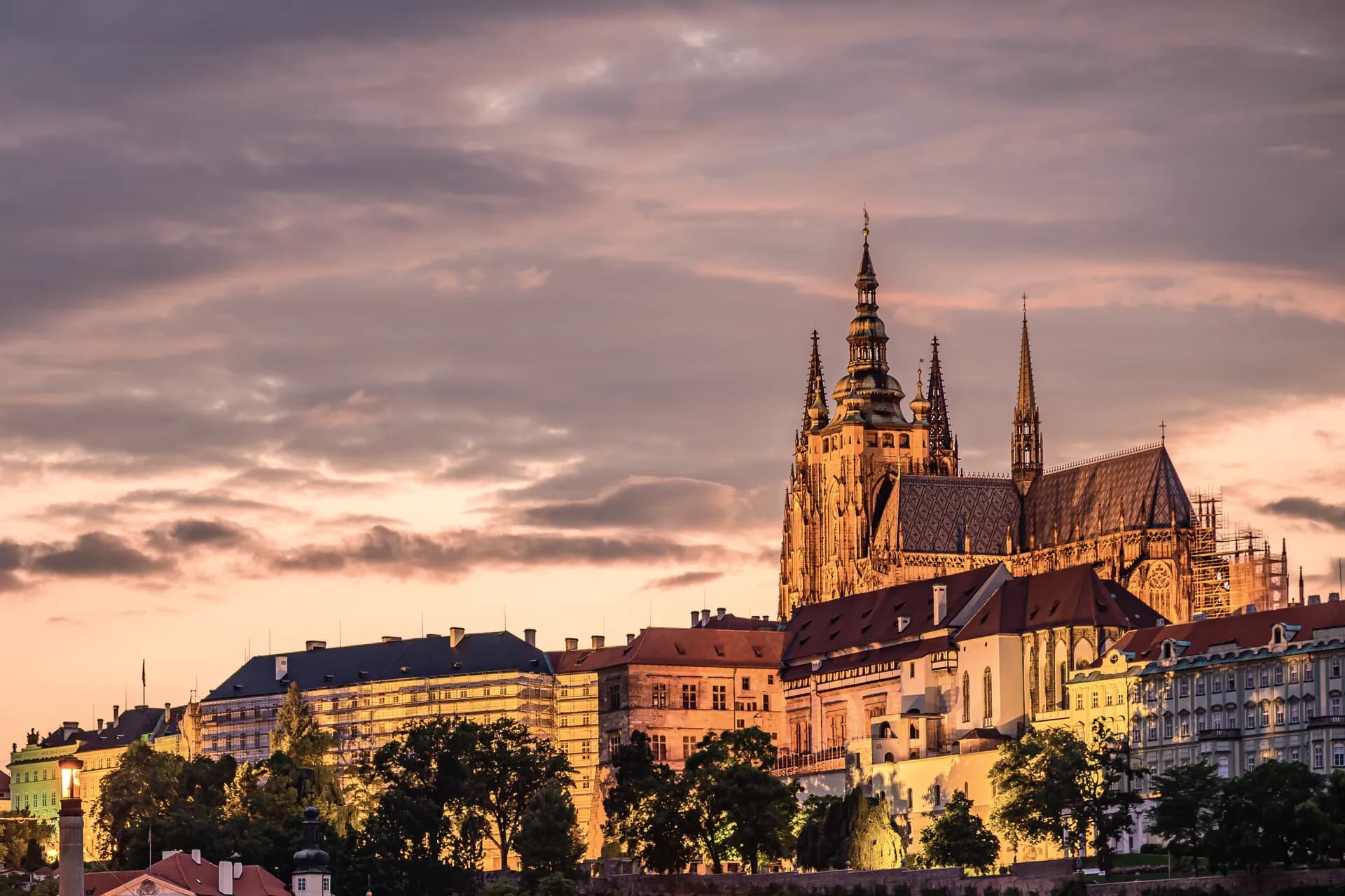 Prague Castle and St Vitus Cathedral above the city roofs at sunset