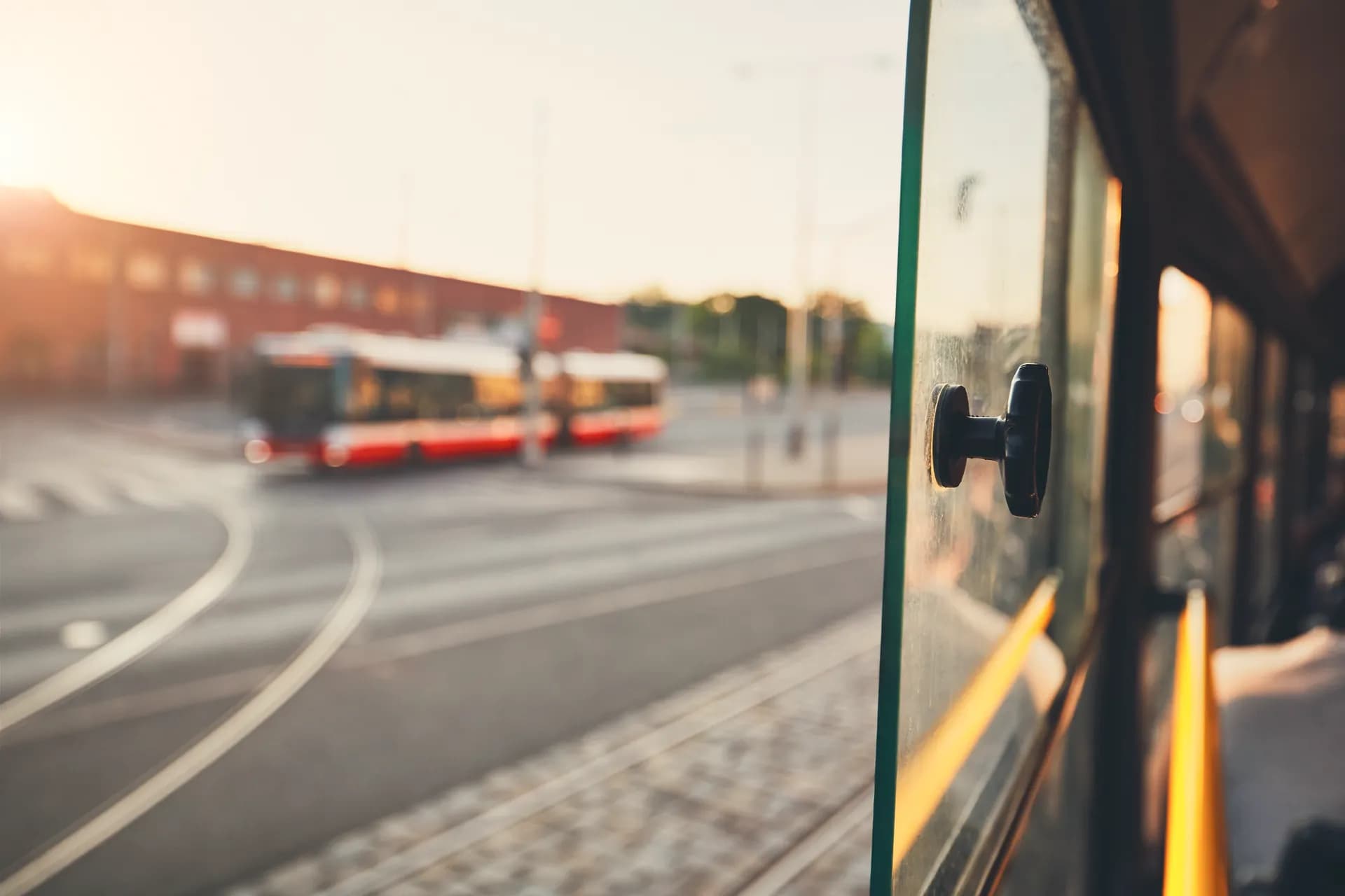 A city bus and tram tracks, seen through a window